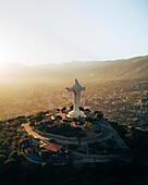 Aerial drone view at sunset of the Christ of Peace in San Pedro Hill, Cochabamba, Bolivia.