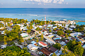 Panoramic aerial view of local, inhabited island Vashafaru at sunset, Maldives, Haa Alif Atoll, Laccadive Sea.
