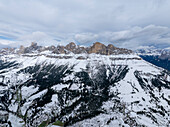 Aerial view of majestic snowy mountains in the dolomites, Welschnofen, Italy.
