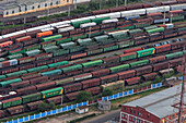 Saint Petersburg, Russia - 11 August 2006: Aerial view of industrial railway network with cargo trains and urban architecture, Saint Petersburg, Russia.