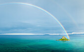 Aerial view of Rainbow over Mokulua Islets Seabird Sanctuary, Kaneohe, Hawaii, United States.