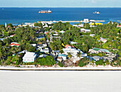 Aerial view of artificial island with palm trees and houses, Maradhoo, Addu Atoll, Maldives.