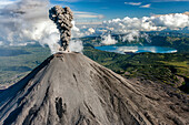 Aerial view of karymsky volcano with smoke plume and crater in a majestic landscape, Kamchatka, Russia.