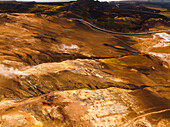 Aerial view of a volcanic hot spring with sulphuric smoke, Namafjall Hverir viewpoint, Northeastern Region, Iceland.