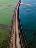 Aerial view of a beautiful road and bridge over Kolgrafarfjordur with tranquil water and scenic landscape, Grundarfjardarbaer, Iceland.
