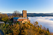 Panoramic aerial sunset view of the castle Yburg with floating fog in autumn, Varnhalt, Black Forest, Baden Baden, Baden Wine Route, Germany.
