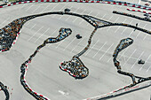 Aerial view of a dynamic karting circuit with racing vehicles and a parking lot, Sochi, Russia.