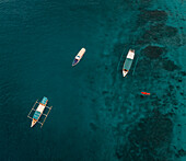 Aerial view of boats in turquoise waters off Gili Islands, Indonesia.