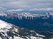 Aerial view of majestic snowy mountains under a clear sky, Welschnofen, Italy.