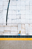 Aerial view of city center square and skateboarder standing near stairs, Kaunas, Lithuania.