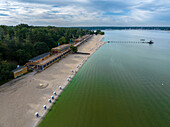 Aerial view of serene strandbad wannsee public beach with sandy shores and tranquil water, Nikolassee, Germany.