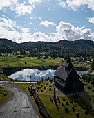 Aerial view of lush mountain landscape with Eidsborg Church and Eidsborg Lagoon, Hoydalsmo, Telemark, Norway.