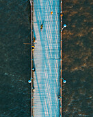 Aerial view of people fishing and walking on bridge in Baltic sea near Palanga, Lithuania.
