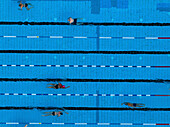 Aerial view of public pools with people swimming and enjoying summer activities, Gesundbrunnen, Berlin, Germany.