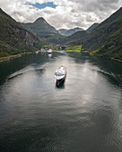 Aerial view of the beautiful Gierangerfjord with a scenic cruise ship amidst tranquil waters and majestic mountains, More og Romsdal, Norway.