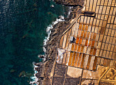Aerial view of beautiful salt flats and ocean with geometric patterns along the coast, Teguise town, Canary Islands, Spain.