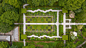 Aerial view of beautifully manicured garden with lush greenery and orderly pathways, Exeter, England.