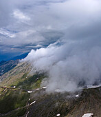 Aerial view of majestic snowy mountains and clouds over Babusar Pass, Khyber Pakhtunkhwa, Pakistan.