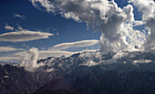 Aerial view of snowy mountains and cloudy sky in Kashmir region, Pakistan.