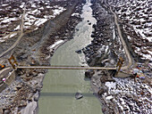 Aerial view of bridge over river amidst snowy rocky terrain, Skardu, Punjab, Pakistan.