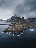 Luftaufnahme eines Leuchtturms vor dem Berg Eystrahorn, Naturschutzgebiet Hvalnes, Austurland, Island
