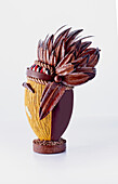 Artistic chocolate Easter egg with feather headdress