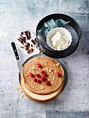 Cake ingredients - cake base, chocolate shavings, cream, raspberries