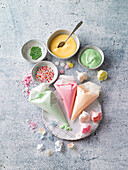 Ingredients for cake decoration - piping bags, icing, sugar pearls