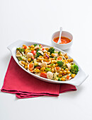 Orecchiette with broccoli and chickpeas in carrot sauce