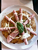 Schiacciata with caper pesto and mortadella
