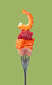 Fork with protein-rich prawns, beef, salmon and chicken