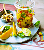 Vegan mango salsa with tomatoes, cashew nuts and agave syrup