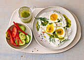 Mediterranean eggs in yoghurt sauce with vegetable salad