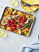 Fried baby snapper with potatoes, lemon and capers