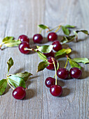 Fresh sour cherries on wooden background