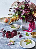 Autumnal bouquet of dahlias and amaranth in ceramic vase