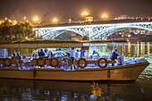 Seville Spain, Nov 3 2018, Girls enjoy a festive bachelorette party on the Guadalquivir River as the Virgin of La Estrella crosses the Triana Bridge in Seville.