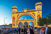 Seville, Spain, Apr 19 2018, Long exposure reveals the festive entrance of the Feria de Abril in Sevilla, where visitors gather under dazzling lights and decorations.