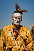 An Amerindian with face paint in period dress at the Fort Bridger Mountain Man Rendezvous in Wyoming.