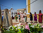 Carrión, Spain, June 19 2025, Women in lace veils gather at the church entrance during the Corpus Christi procession in Seville, highlighting Andalusian heritage.