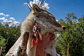 A mountain man in period dress with a coyote-skin hat at the Fort Bridger Mountain Man Rendezvous in Wyoming.