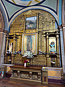 An altarpiece in a side chapel with a painting of the Virgin in the El Sagrario Church in Quito, Ecuador.