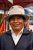 A Quechua Amerindian man with a traditional fedora hat in the market in Otavalo, Ecuador.