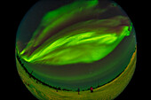 A fish-eye 360° view of the fine display of Northern Lights on February 25, 2025, with a complex of curtains passing overhead and across the sky from northeast (at lower left) to southwest (at upper right), with Venus setting at far right. Orion and Sirius are at bottom centre to the south.