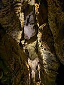 A chockstone overhead in a narrow passageway in the Middle Cave in Timpanogos Cave National Monument, Utah.