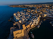 Aerial view of Porto Antico, the historic old port, the Marina, Castello Carlo V and the old town, Monopoli, Italy