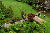Staff carrying baggage at the Yarina Ecolodge by the Napo River in the Amazon Basin of Ecuador.