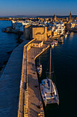 Aerial view of Porto Antico, the historic old port, the Marina, Castello Carlo V and the old town, Monopoli, Italy