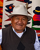 A Quechua Amerindian man with a traditional fedora hat in the market in Otavalo, Ecuador.