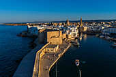 Aerial view of Porto Antico, the historic old port, the Marina, Castello Carlo V and the old town, Monopoli, Italy